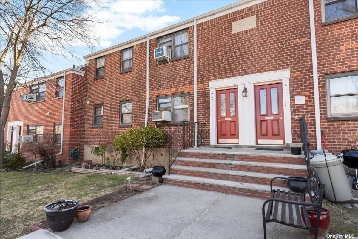 A red brick building with steps leading to the front door.