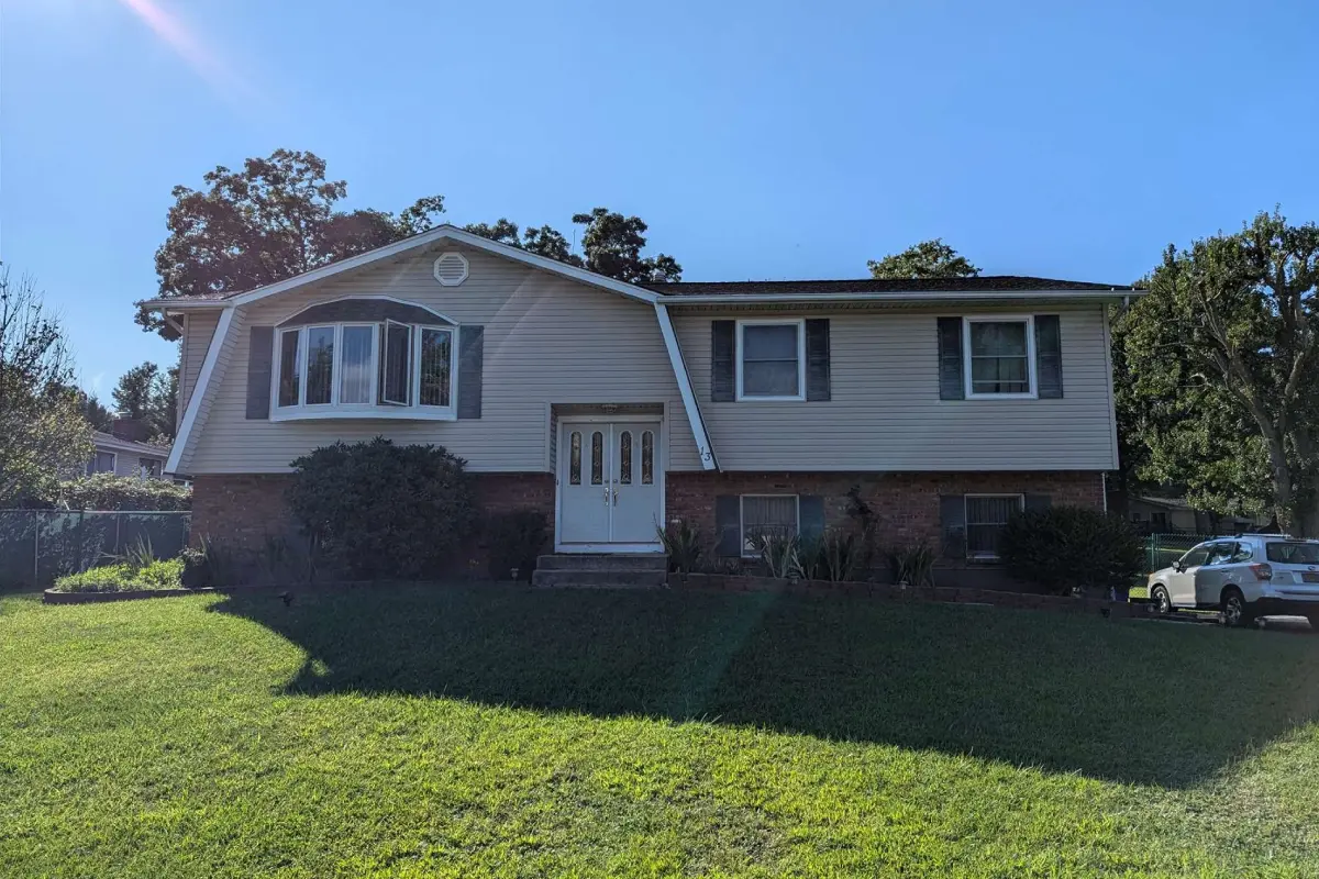 A house with grass and trees in front of it